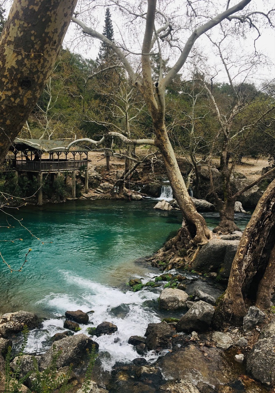 A group paddling a raft on the turquoise Koprucay River in Koprulu Canyon
